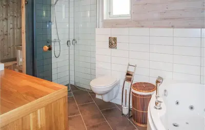 a bathroom with a toilet and a shower and a sink at Amazing Home In Hol With Sauna in Hol