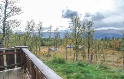 a balcony with a view of a field and trees at Amazing Home In Hol With Sauna in Hol