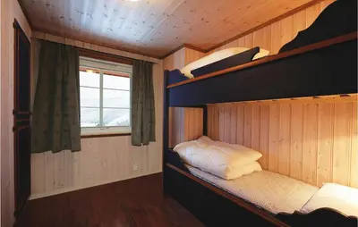 a bunk bed in a room with a window at Skarsnuten in Hemsedal