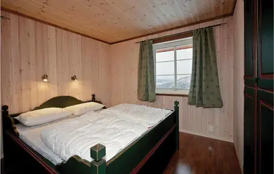 a bedroom with a bed in a room with a window at Skarsnuten in Hemsedal