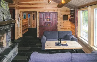 a living room with a couch and a table at Skarsnuten in Hemsedal