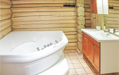 a bathroom with a white tub and a sink at Skarsnuten in Hemsedal