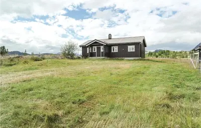 a house on a hill with a grassy field at Beautiful Home In Hemsedal With Kitchen in Hemsedal
