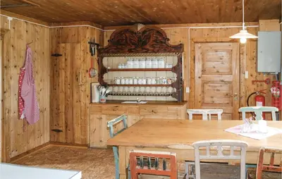 a kitchen with a table and a wooden wall at Beautiful Home In Hemsedal With Kitchen in Hemsedal