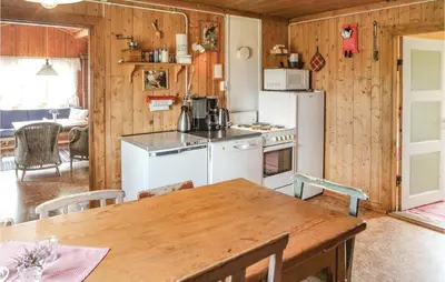 a kitchen with a table and a white refrigerator at Beautiful Home In Hemsedal With Kitchen in Hemsedal