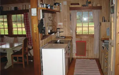 a kitchen with a sink and a table in a cabin at Holiday Home Hemsedal Rusto Raunhaug in Hemsedal