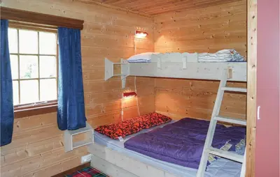 a bedroom with bunk beds in a wooden cabin at Holiday Home Hemsedal Rusto Raunhaug in Hemsedal