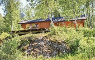 a red cabin in the middle of a forest at Vinjebu in Hemsedal