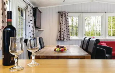 a table with two wine glasses and a bowl of fruit at Vinjebu in Hemsedal