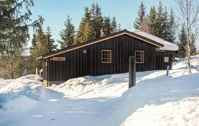 a small cabin in the snow with snow around it at Månebu in Nesbyen