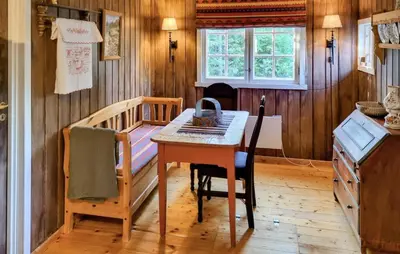 a kitchen with a table and a bed in a room at Månebu in Nesbyen