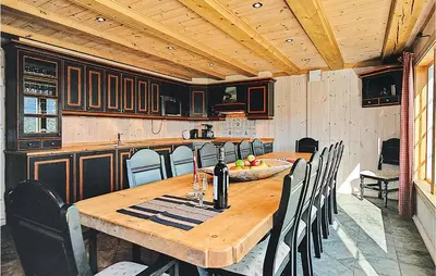 a wooden table and chairs in a kitchen at Nice Home In Hemsedal With Sauna in Hemsedal