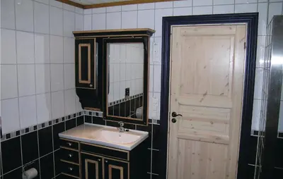 a bathroom with a sink and a mirror and a door at Holiday Home Hemsedal Høgeloft in Hemsedal