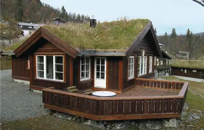 a small house with a grass roof on a deck at Holiday Home Hemsedal Høgeloft in Hemsedal