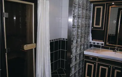 a bathroom with a sink and a shower with a shower curtain at Holiday Home Hemsedal Høgeloft Ii in Hemsedal
