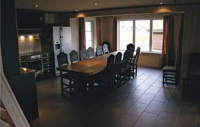 a kitchen and dining room with a wooden table and chairs at Holiday Home Hemsedal Høgeloft Ii in Hemsedal