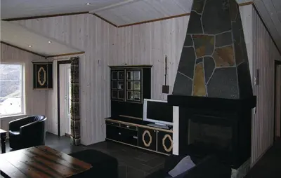 a living room with a fireplace and a tv at Holiday Home Hemsedal Høgeloft Ii in Hemsedal