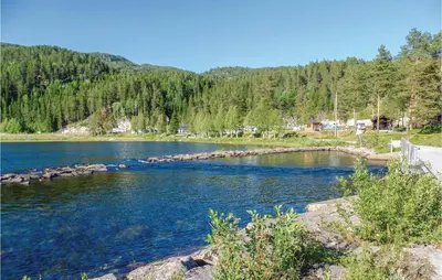 a view of a river with trees in the background at Sundflathytta in Nesland