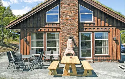 a log cabin with a picnic table and chairs at Lovely Home In Rauland With Sauna in Rauland