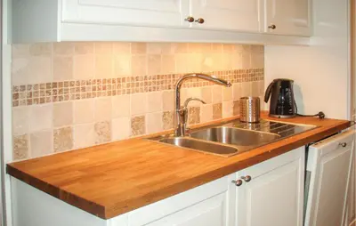 a kitchen with a sink and wooden counter top at Lovely Home In Rauland With Sauna in Rauland
