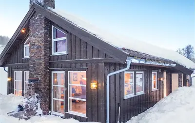 a log cabin in the snow with snow at Lovely Home In Rauland With Sauna in Rauland