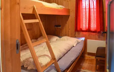 a bunk bed with a ladder in a room at Holiday Home Hurdal Steinsjøveien in Hurdal