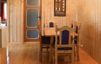 a dining room with a wooden table and chairs at Holiday Home Hurdal Steinsjøveien in Hurdal