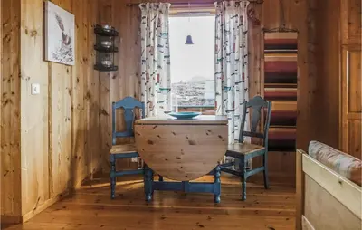 a table and two chairs in a room with a window at Holiday Home Vallersund Nausthylla Haldorhamn in Valsøya