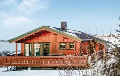 a small wooden house in the snow at Holiday Home Vallersund Nausthylla Haldorhamn in Valsøya