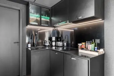 a kitchen with black cabinets and a counter top at Sogndal Fjordpanorama in Sogndal