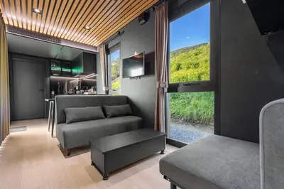 a living room with a couch and a table at Sogndal Fjordpanorama in Sogndal