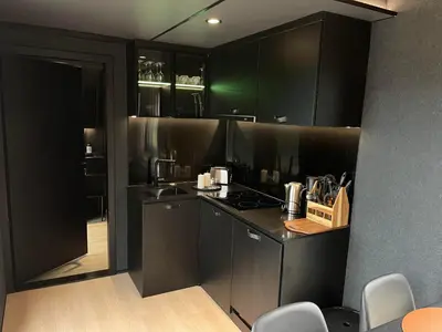 a kitchen with black cabinets and a counter top at Sogndal Fjordpanorama in Sogndal