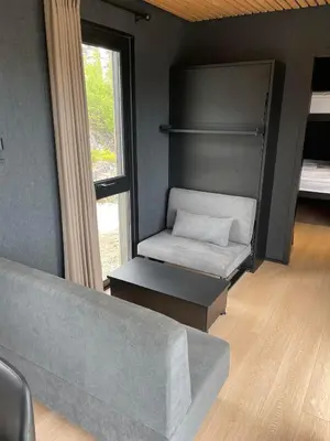 a living room with a couch and a window at Sogndal Fjordpanorama in Sogndal