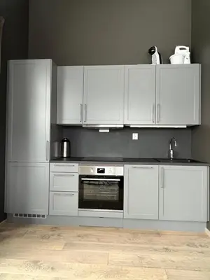 a kitchen with white cabinets and an oven at Trysil Alpine Lodge in Trysil