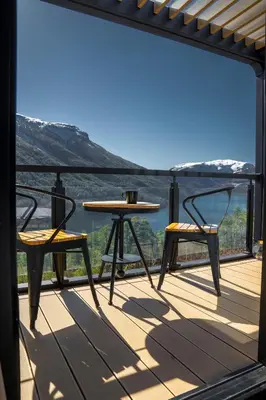 a table and two chairs on a deck with a view at Sogndal Fjordpanorama - The view in Sogndal