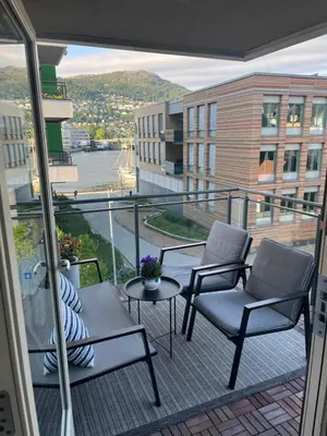 a balcony with two chairs and a table and a view at Modern Apartment - Amazing Terrace and Fjord View, Close to City Center in Bergen