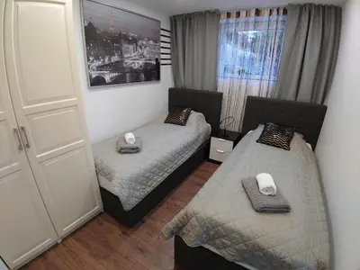 a bedroom with two beds and a window at Bergen sunrise Apartment - self check in - Free Parking in Bergen