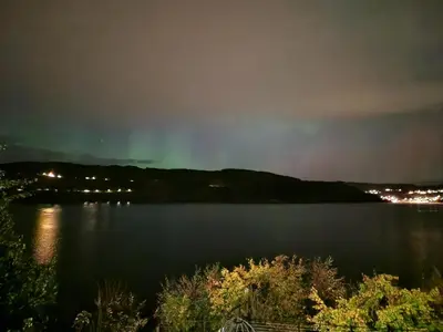 a view of a lake at night at Bergen sunrise Apartment - self check in - Free Parking in Bergen