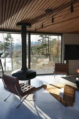 a living room with a chair and a fireplace at VILLA KRISTINA / ÅNDALSNES in Torvik