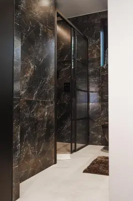 a pair of glass doors in a room with a stone wall at VILLA KRISTINA / ÅNDALSNES in Torvik
