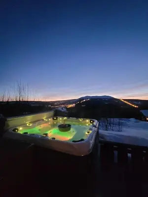 a jacuzzi tub with lights in the snow at ReveEnka - cabin in Trysil with Jacuzzi for rent in Trysil