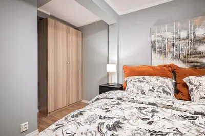 a bedroom with a bed and a painting on the wall at Rosen Apartment in Bergen