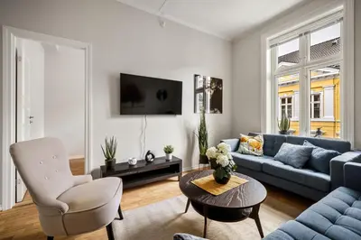 a living room with a blue couch and a table at Rosen Apartment in Bergen