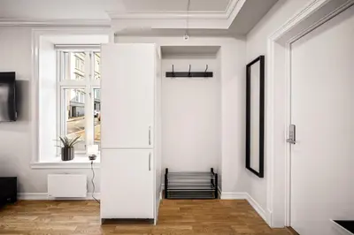 a room with a white door and a window at Rosen Apartment in Bergen
