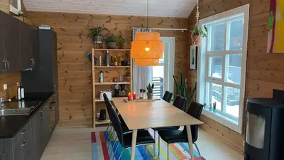 a dining room with a wooden table and chairs at Penthouse by the ski lift, 4 bedrooms, 2 living rooms in Stranda