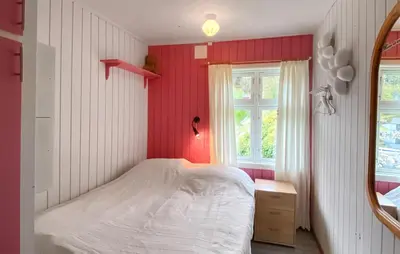 a bedroom with a white bed and a mirror at Cozy Home In Vanvik With Wifi in Vanvik