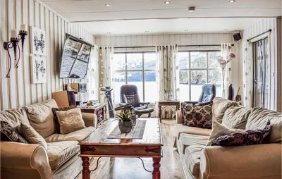 a living room with two couches and a table at Cozy Home In Vanvik With Wifi in Vanvik
