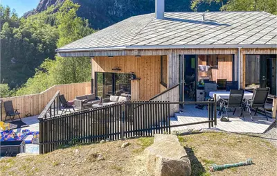 a wooden house with a porch and a patio at 4 Bedroom Gorgeous Home In Erfjord in Erfjord