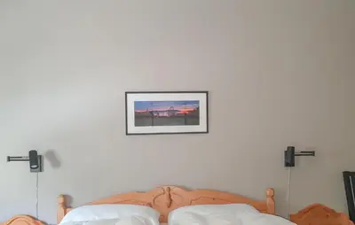 a bedroom with a bed with a picture on the wall at 5 Bedroom Lovely Home In Bjoa in Utbjoa