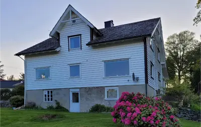 a large white house with flowers in the yard at Gorgeous Home In Reksteren With Kitchen in Hope